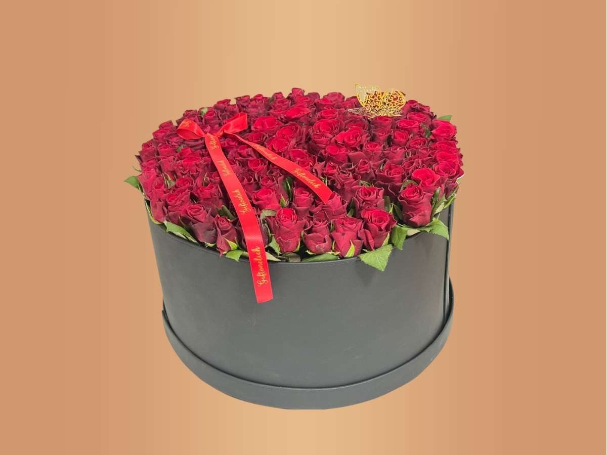  round box filled with 100 red roses 