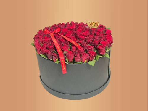  round box filled with 100 red roses 