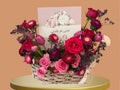 Bouquet of flowers in a basket with a card on a beige background