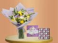 Best Mum bundle-Bouquet of flowers with a chocolate box on a round platform against an orange background-Lebanon