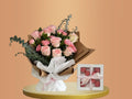 Bouquet of flowers and a box of chocolates on a peach background