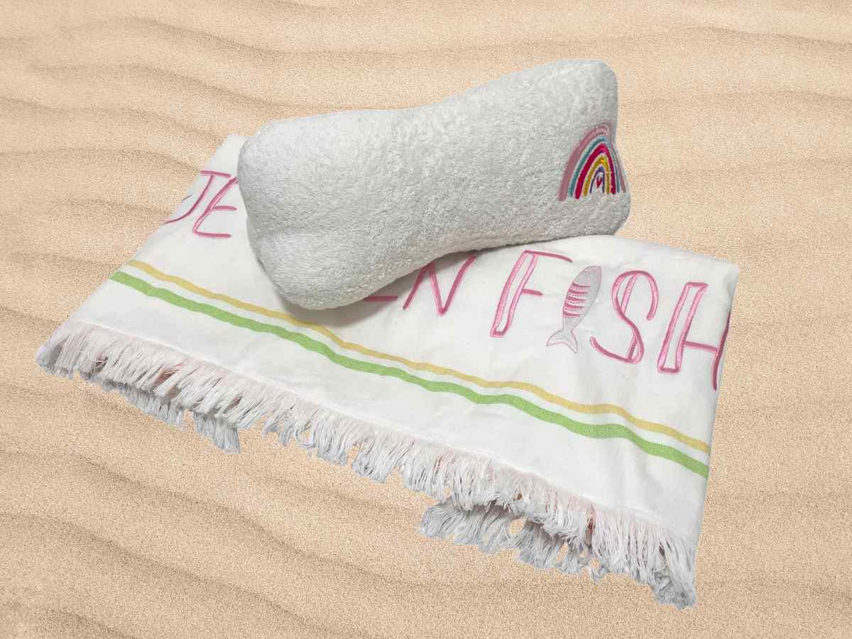 embroidered beach towel and pillow set in white and multicolor
