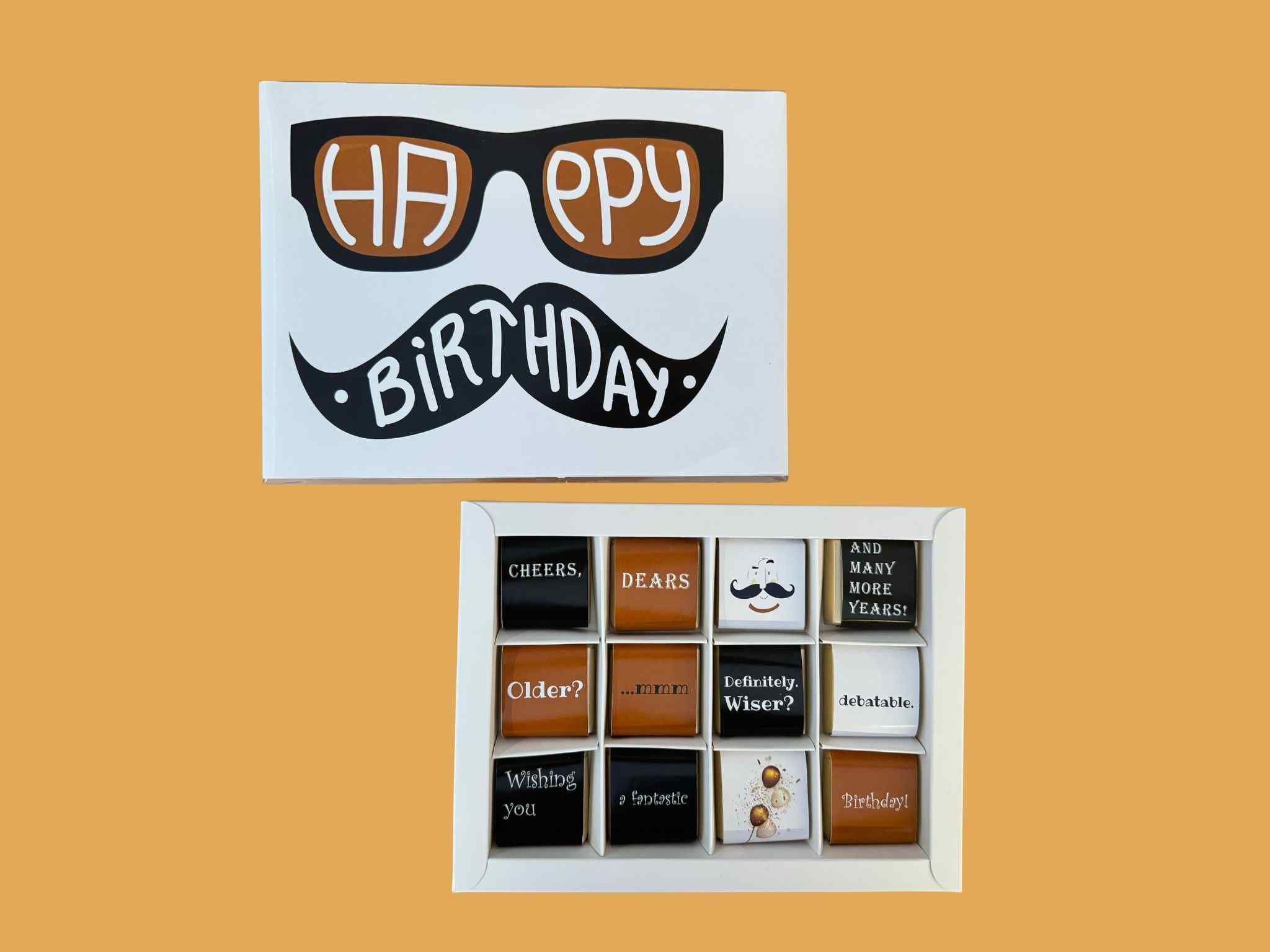 Box of chocolates with a birthday cover featuring sunglasses and a mustache