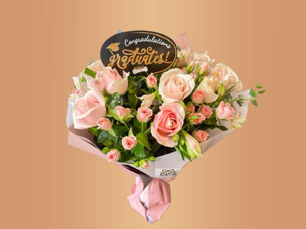 Bouquet of pink flowers with a 'Congratulations' sign