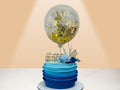 cake with blue layered design and balloon