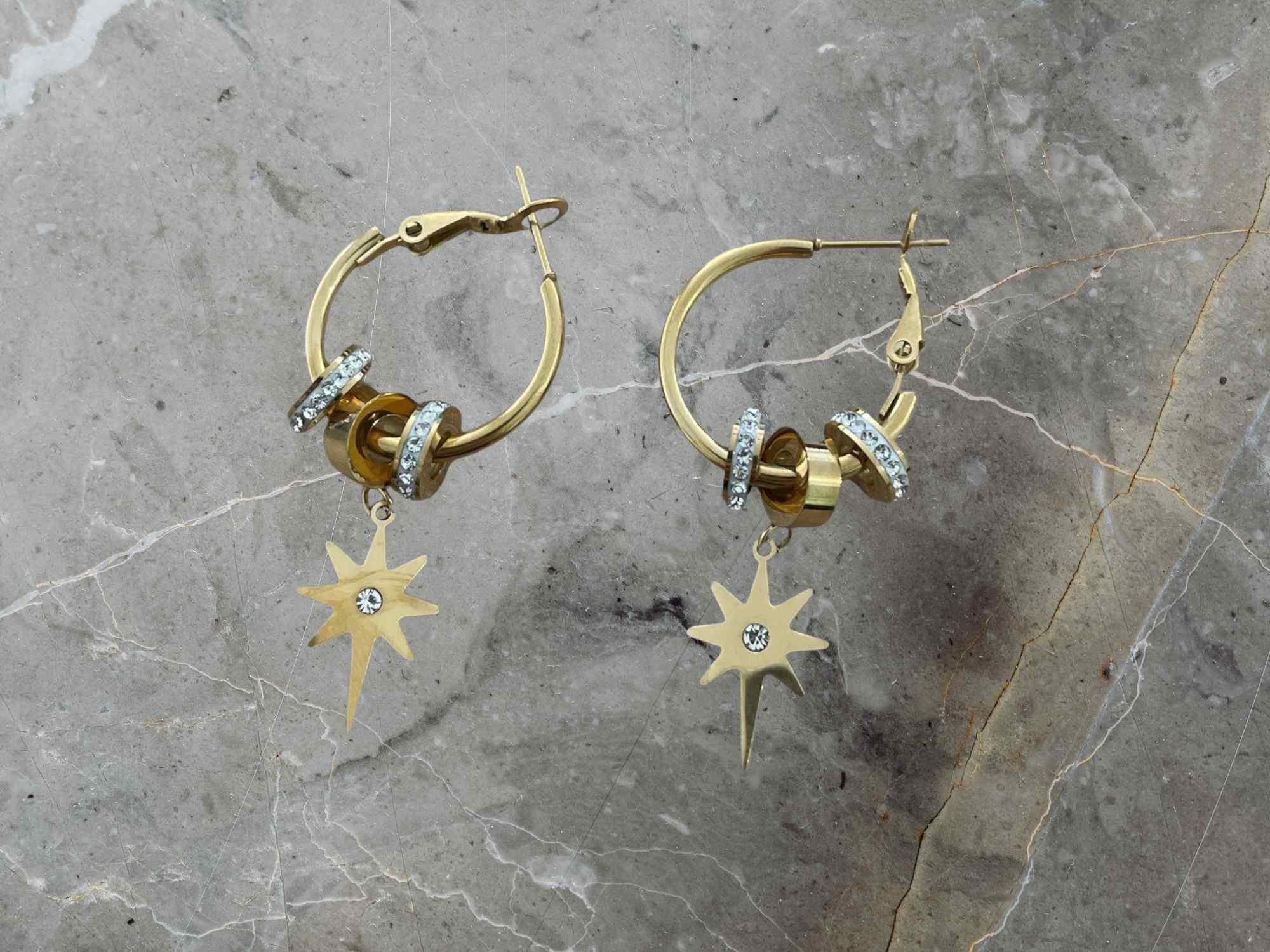 Gold hoop earrings with star-shaped charms 