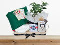 gift with cards round table cover, marble cigar ashtray, a chocolate bar, a Bonsai tree, and a mug filled with chocolate pieces, nuts, and dragee chocolates