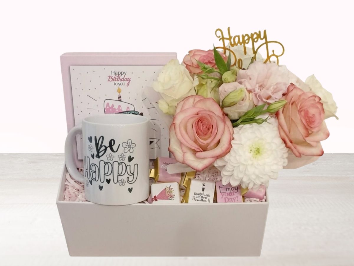 giftbox with chocolate box, mug and flower arrangement with happy birthday topper