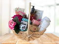 giftbasket with embroidered hand towels, mug, lotion, candle, soap, and chocolates