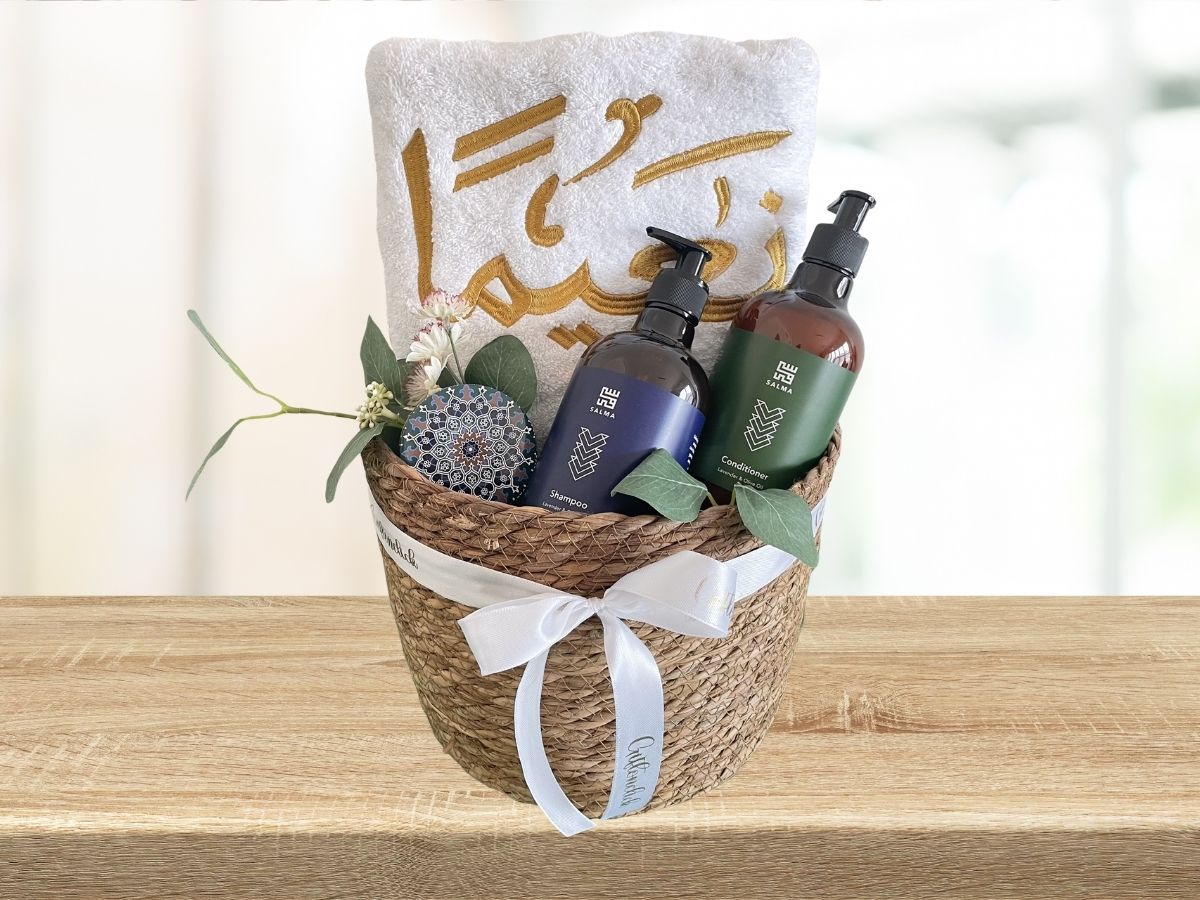 gift basket with embroidered towel, shampoo and conditioner set and soap bar