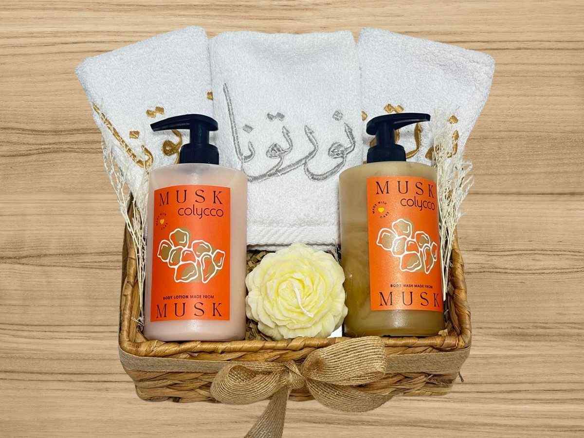embroidered hand towels, body lotion and hand wash set with decorative candle