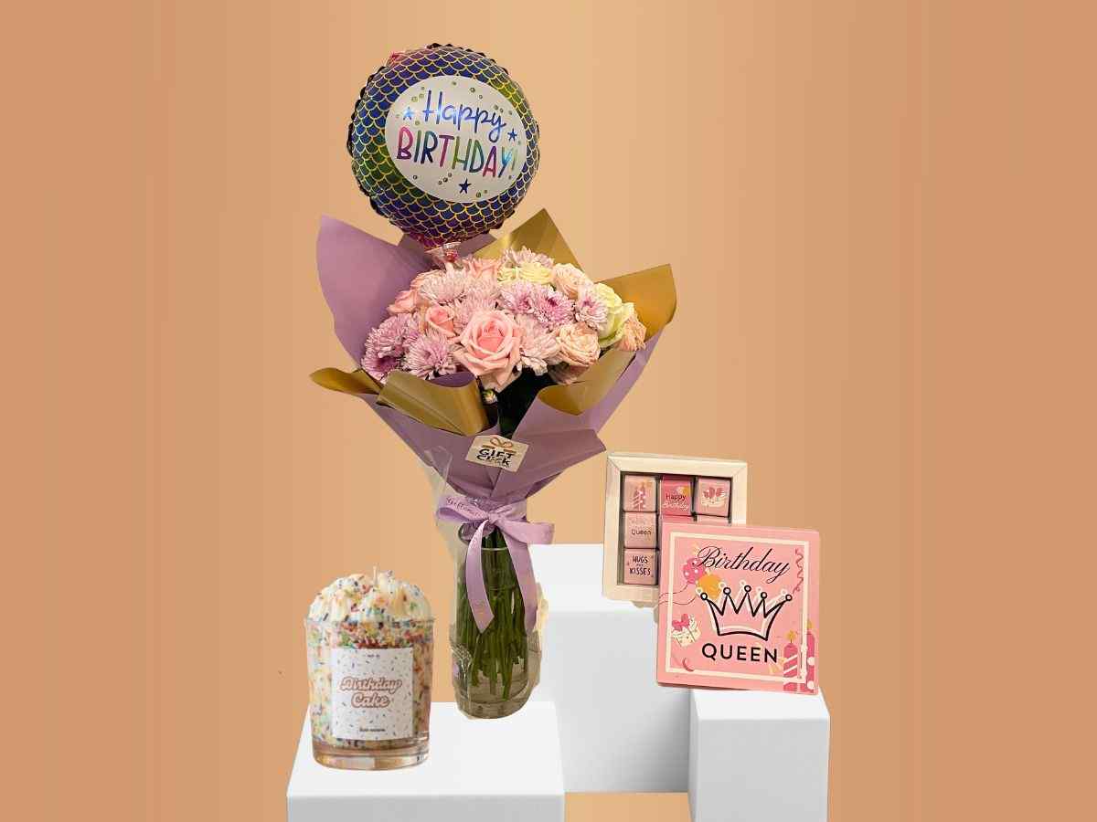 bundle with bouquet, balloon, candle and chocolate box