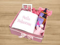 embroidered towel, chocolates, candle and strawberry scented shower gel and shampoo for babies