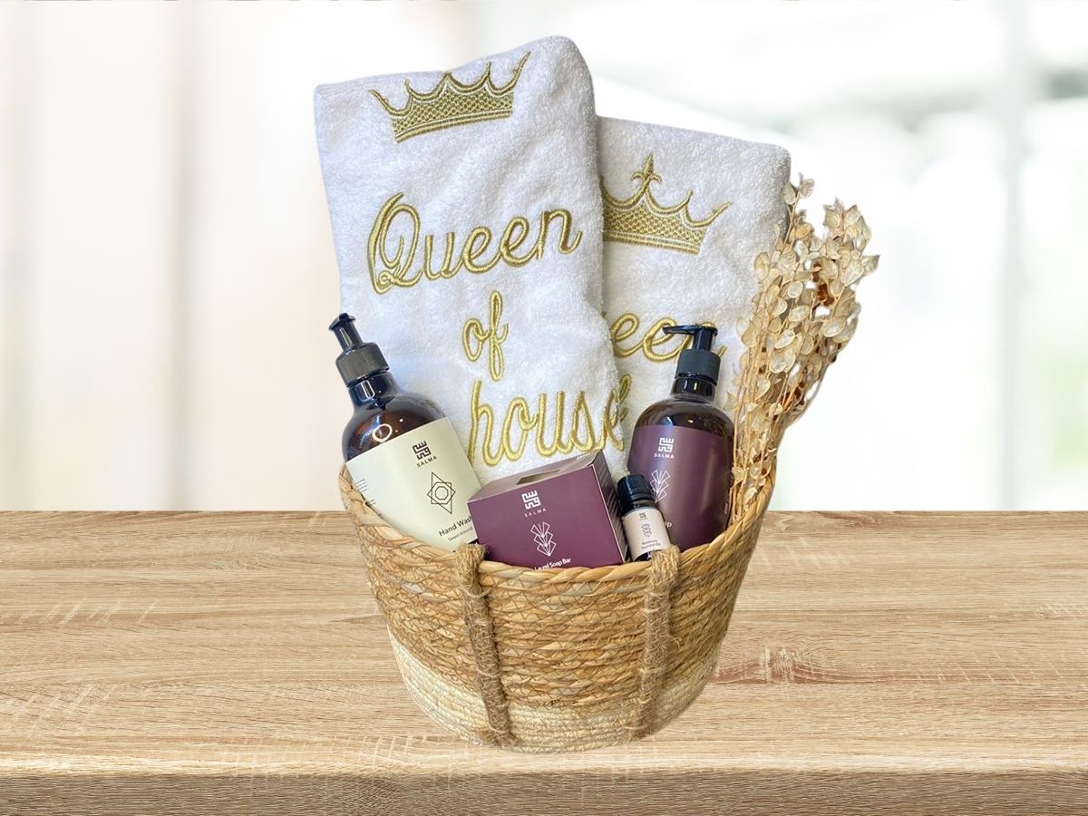 gift basket with queen of the house embroidered towels, hand wash, lotion, soap and essential oil