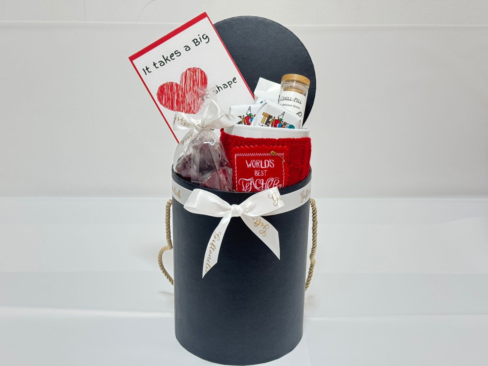 Gift basket with a red card, mug, and chocolates for teachers