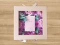 giftbox with feminine perfume surrounded by fresh flowers