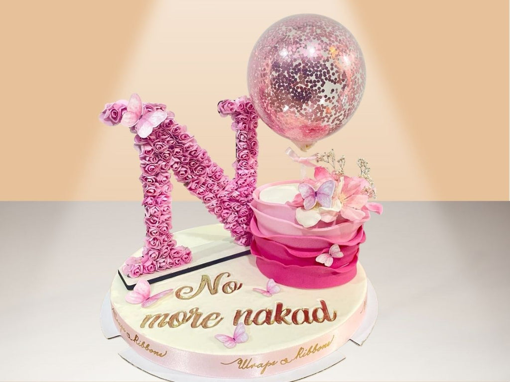 single ruffle cake with flower letter