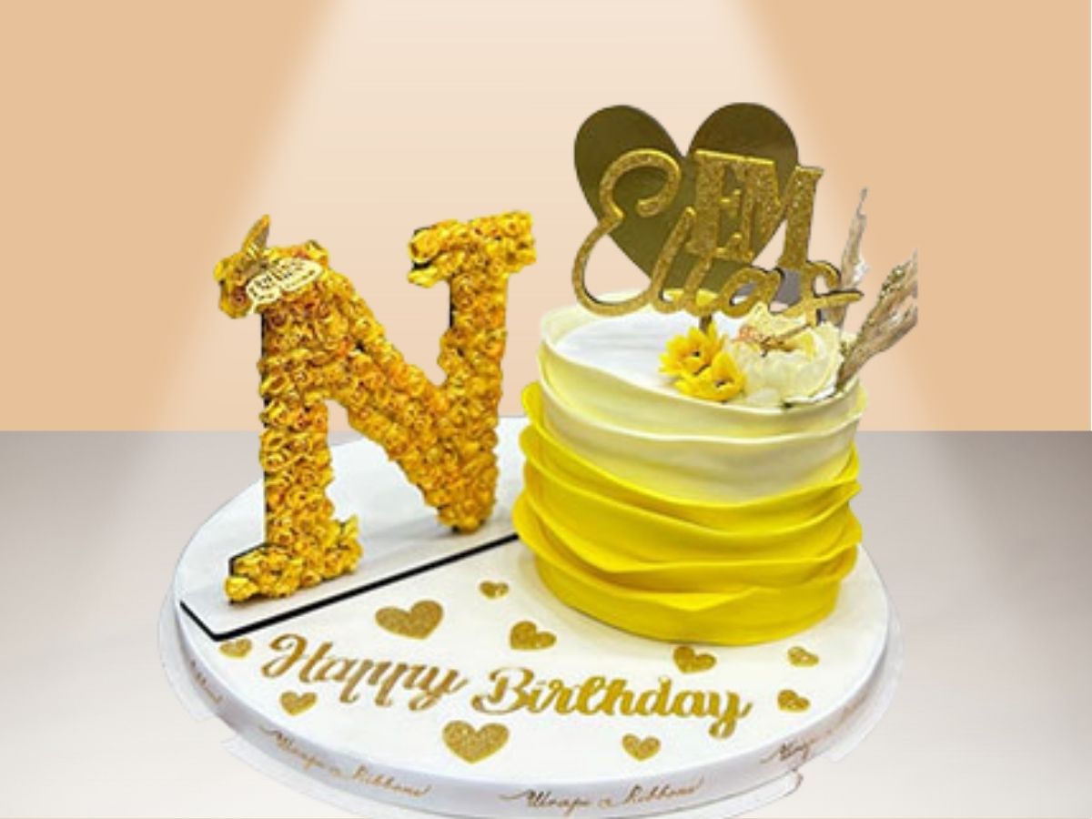 single ruffle cake with flower letter