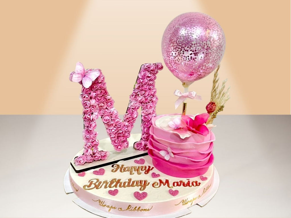single ruffle cake with flower letter
