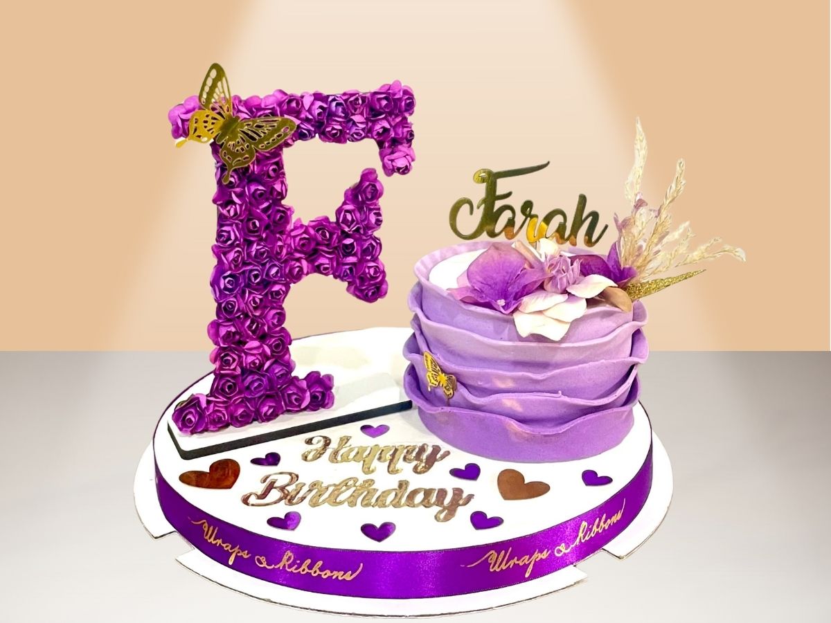 single ruffle cake with flower letter