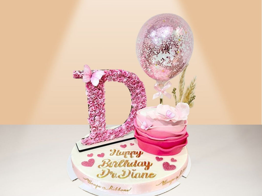 single ruffle cake with flower letter
