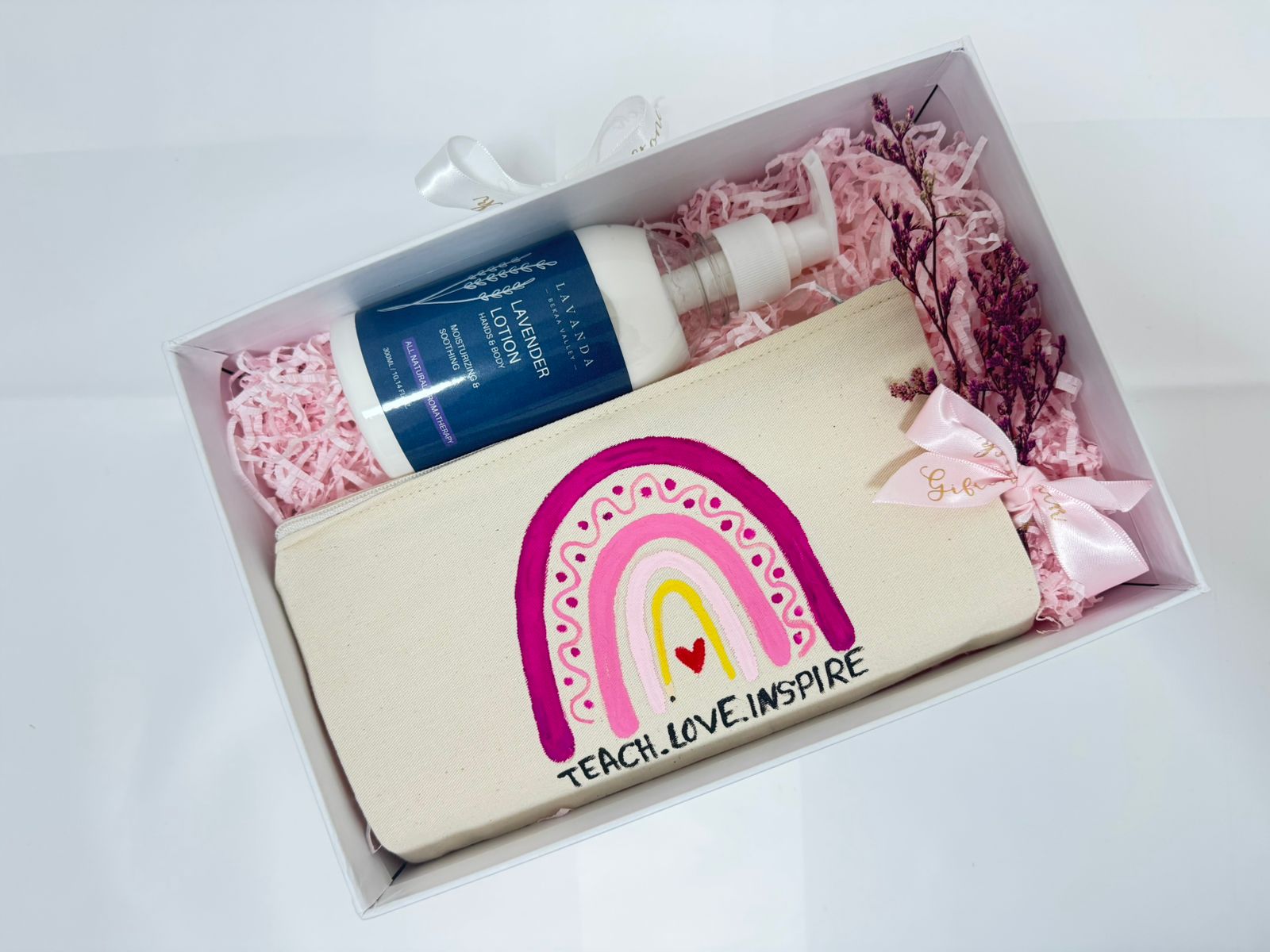Gift set with pouch, lotion, and flowers in a box 