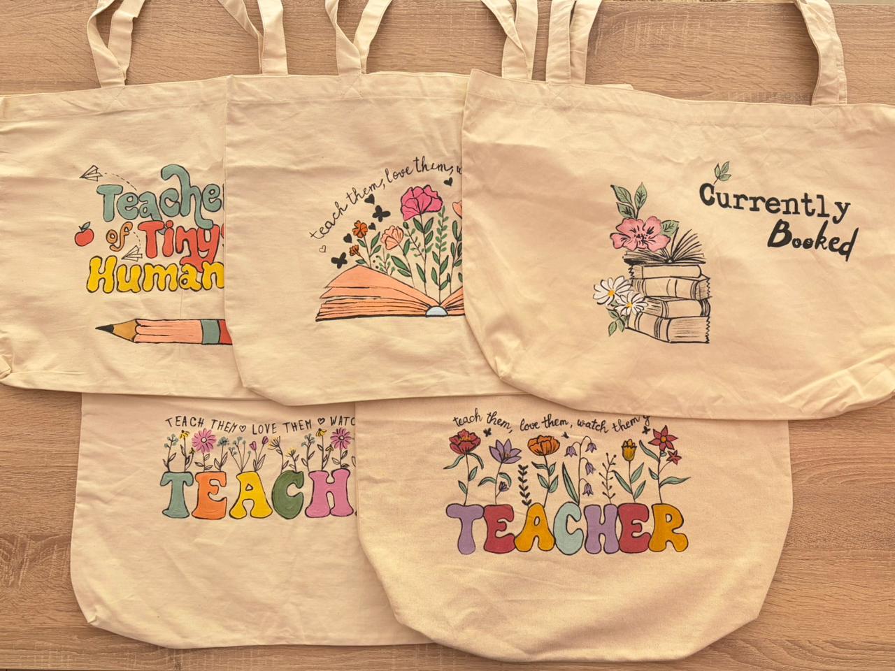 beige tote bags with colorful text and graphics for teachers