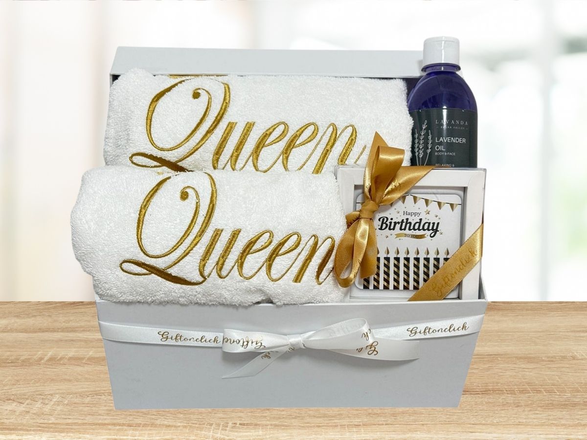 two queen embroidered towels, lavender oil and chocolate bar with happy birthday message
