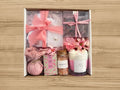 giftbox with candle, bath salts, soap, bath bomb, face roller, tea bag and necklace