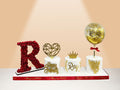 three cakes on board with flower letter and balloon